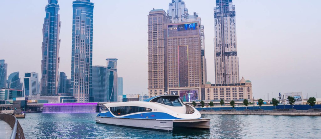 Interior and exterior views of the Dubai to Sharjah ferry showing comfortable seating and Arabian Gulf views