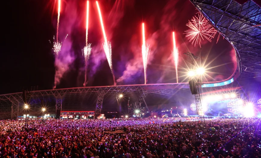 The iconic Etihad Park stage illuminated at night during previous Abu Dhabi Grand Prix concerts.