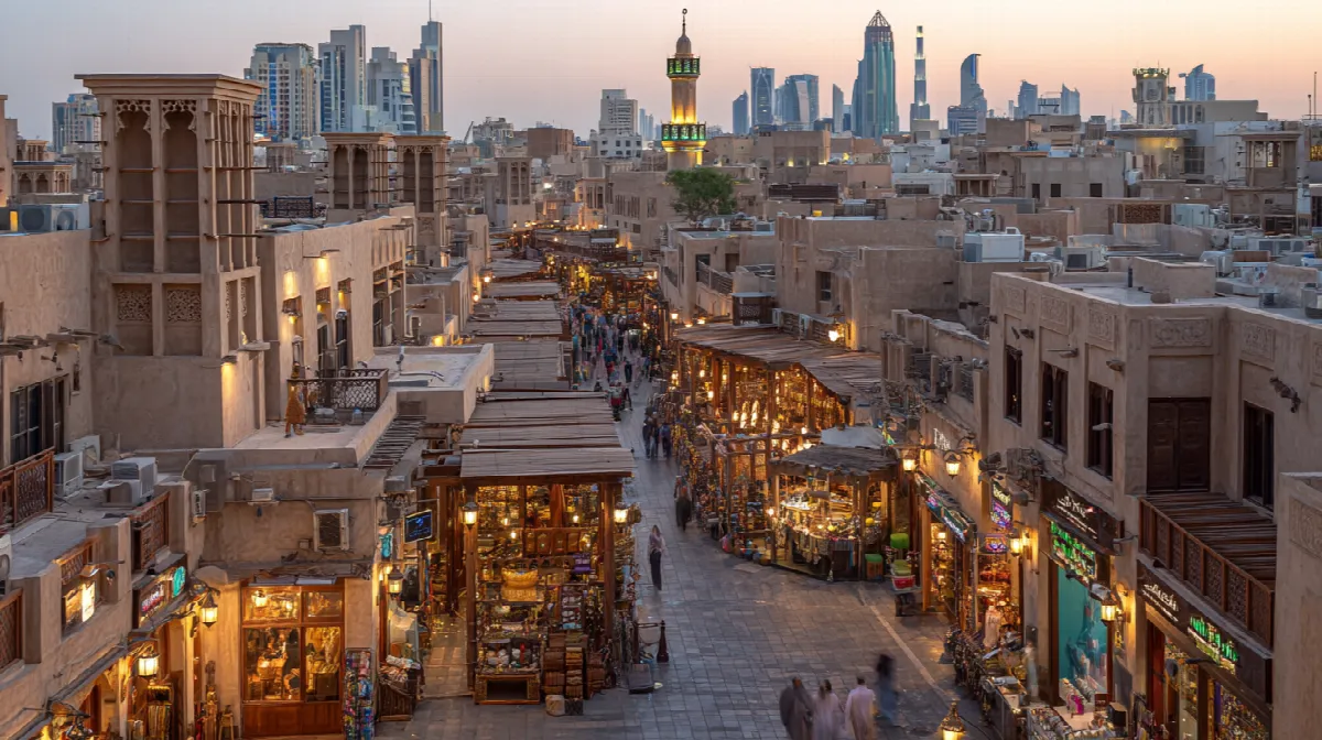 Aerial view of Dubai's famous Deira Gold Souq showing traditional covered walkways with gold shops and modern skyline