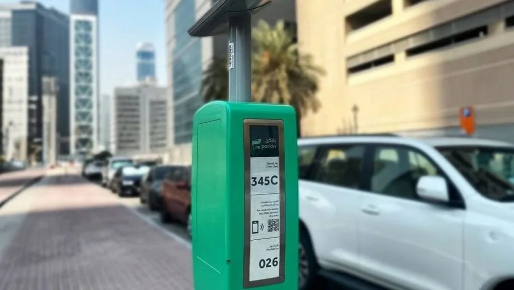 Woman using Parkin mobile app to manage her parking subscription in Dubai